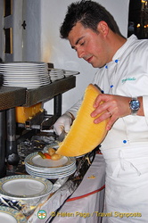 Chef preparing raclette