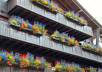 Colourful floral baskets at this Zermatt chalet