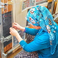 Handweaving silk carpets - a backbreaking task